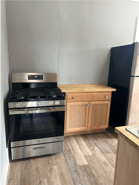 a small kitchen with a stove and a refrigerator